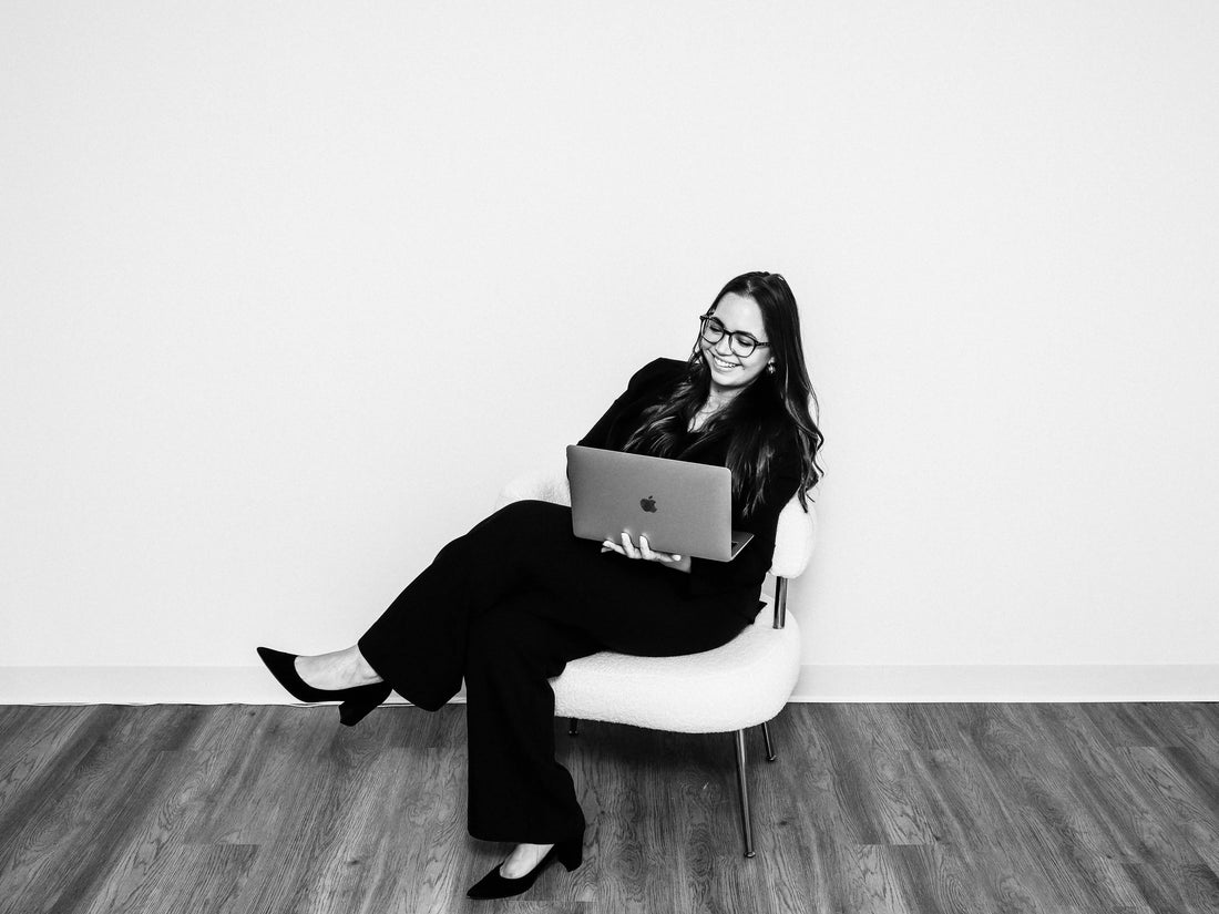Nicole Hidalgo holding laptop smiling